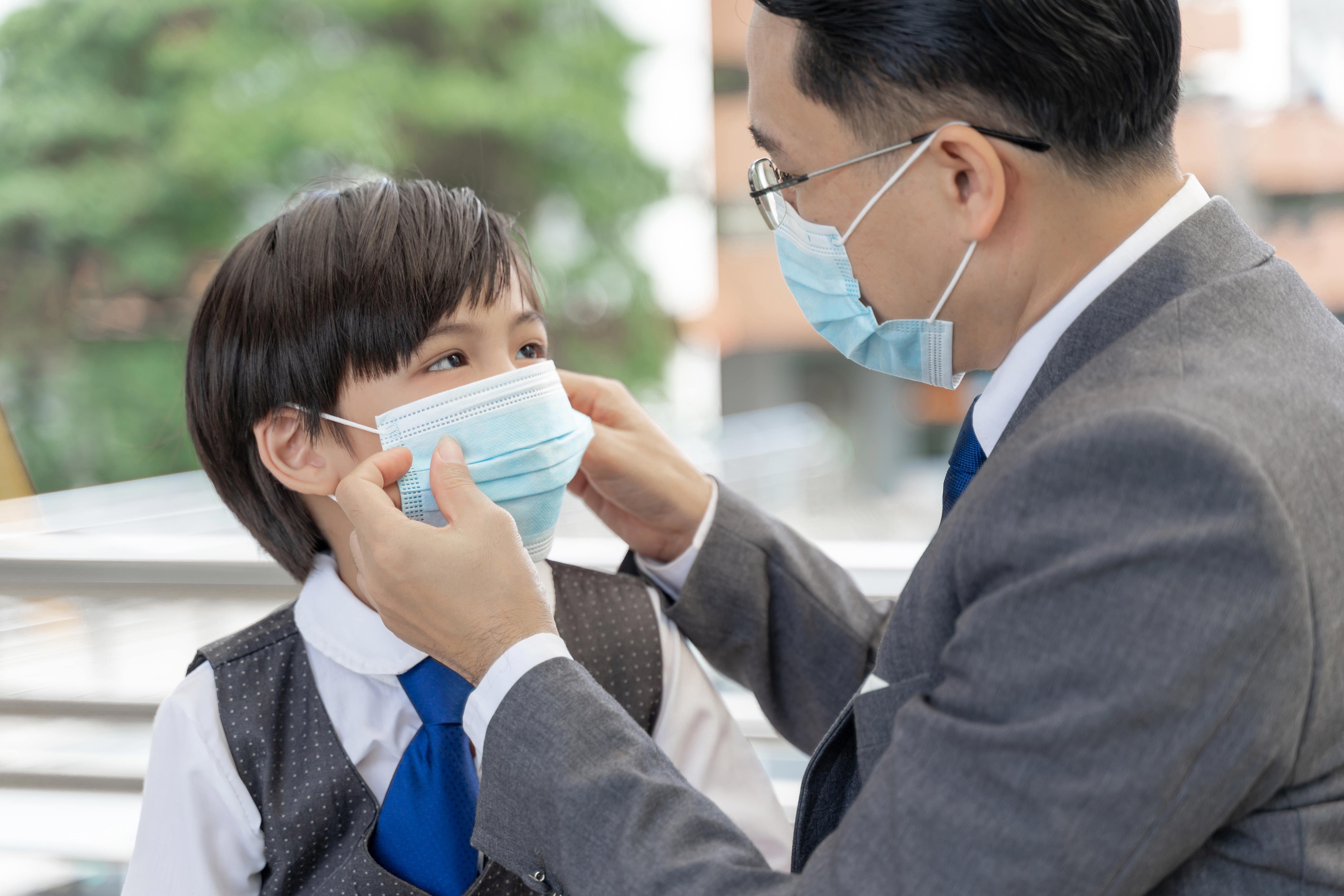 father putting protective mask his son asian family wearing face mask protection during quarantine coronavirus covid 19 outbreak